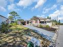 Charming single-Gathering home with a well-manicured yard and a long driveway at 807 Saint Charles Dr, Tarpon Springs, FL 34689