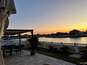 Enjoy this back patio with a beautiful water view and pergola, perfect for outdoor dining at 924 Peregrine Hill Pl, Ruskin, FL 33570