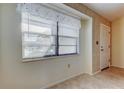 Bright entryway featuring neutral walls, large window, and tile flooring at 11429 Nest Ct, Port Richey, FL 34668