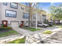 Townhome exteriors featuring neutral paint, dark trim, garages, and well-maintained landscaping at 1208 Chatham Pine Pl, Brandon, FL 33511