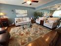 Inviting living room with a large floral rug, comfortable seating, and stylish decor at 1235 S Highland Ave # 1-204, Clearwater, FL 33756