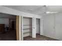 Bedroom closet with folding doors and wire shelving for organization at 124 Buttonwood Cir # 124, Seminole, FL 33777