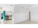 Open floorplan with light walls and floors, a kitchen, and access to a screened-in patio at 12400 Park Blvd # 524, Seminole, FL 33772