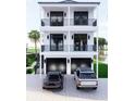 Elegant two-story home with double balconies, black trim, and a convenient two-car garage at 18530 Gulf Blvd, Indian Shores, FL 33785