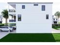 Side view of the property, highlighting its clean lines, ample parking, and outdoor space at 18530 Gulf Blvd, Indian Shores, FL 33785