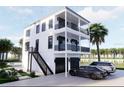 Beautiful home featuring an exterior stairway, dark trim, and a spacious two-car garage at 18530 Gulf Blvd, Indian Shores, FL 33785