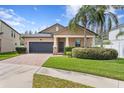 Attractive single-Gathering home with a brick driveway, well-maintained lawn, and mature trees at 19476 Paddock View Dr, Tampa, FL 33647