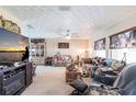Spacious living room featuring a ceiling fan, large windows, and comfortable seating at 2466 Lake View Blvd, Port Charlotte, FL 33948