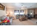 Inviting living room featuring comfortable seating, natural light, and a ceiling fan for added comfort at 2466 Lake View Blvd, Port Charlotte, FL 33948