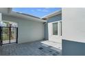 Private courtyard with paver flooring and gated access, offering an intimate outdoor space at 33759 Ocean Spray Ln, Wesley Chapel, FL 33543