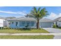 Charming one-story home featuring manicured lawn, decorative shutters, and a well-kept exterior at 33759 Ocean Spray Ln, Wesley Chapel, FL 33543