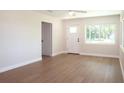 Well lit open concept living room with hardwood floors and views out the windows at 4019 W Lemon St, Tampa, FL 33609