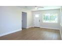 Inviting living room features hardwood floors, a ceiling fan, and a bright window at 4019 W Lemon St, Tampa, FL 33609