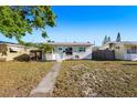 Charming single-story home with a well-maintained front yard and inviting walkway to the front door at 679 71St N Ave, St Petersburg, FL 33702