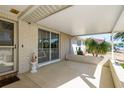 Charming covered patio with brick accents and ample space for outdoor living and dining at 6905 El Camino Paloma St, Port Richey, FL 34668
