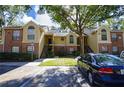 Charming condo exterior with brick accents, manicured lawn, and ample parking in a well-maintained community at 8647 Mallard Reserve Dr # 104, Tampa, FL 33614