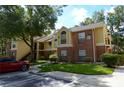 Well-maintained condo building with brick and siding, lush landscaping, and convenient parking at 8647 Mallard Reserve Dr # 104, Tampa, FL 33614