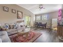 Living room with vaulted ceilings, modern decor, and a view into the dining area and sliding door at 10205 Courtney Palms Blvd # 304, Tampa, FL 33619