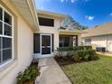 Inviting front entrance with a charming walkway and well-maintained landscaping at 1042 Trafalgar Dr, New Port Richey, FL 34655