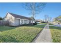 Well-maintained home exterior with a large front yard and a sidewalk leading to the street at 15742 Scrimshaw Dr, Tampa, FL 33624