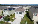 Aerial view of a gray two-story home with dark shutters and a well-maintained lawn at 16849 Trite Bend St, Wimauma, FL 33598