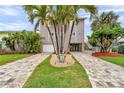 Beautiful two-story home with lush landscaping and a spacious driveway at 17404 1St E St, Redington Shores, FL 33708