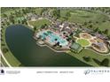 Aerial view of community amenities, including pool, clubhouse, and recreational facilities next to lake at 17976 Foxtail Loop, Venice, FL 34293