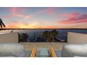 Enjoy colorful sunsets from this home's balcony overlooking the open bay and boat dock at 1843 Bayou Grande Ne Blvd, St Petersburg, FL 33703