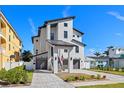 Modern three-story home with a contemporary design, featuring a two-car garage and stylish landscaping at 1843 Bayou Grande Ne Blvd, St Petersburg, FL 33703