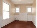 Bright living room with hardwood floors, painted fireplace, and many windows at 2018 Elmwood Ave, Tampa, FL 33605
