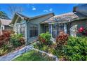 Charming home exterior showcasing lush landscaping and well-maintained curb appeal at 2446 Bentley Dr, Palm Harbor, FL 34684