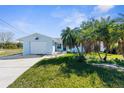 Charming single-story home features a light blue exterior, lush lawn, and a one-car garage at 4390 6Th Isle Dr, Hernando Beach, FL 34607