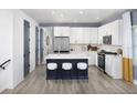 Modern kitchen features a center island with seating, stainless steel appliances, and white cabinets at 4717 W Mccoy St # 18, Tampa, FL 33616