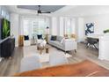 Bright living room with large windows, modern decor, a comfortable seating area, and stylish accents at 4717 W Mccoy St # 18, Tampa, FL 33616
