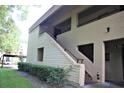 Exterior view of an apartment building with staircases, showing building design and landscaping at 4983 Puritan Cir # 524, Tampa, FL 33617