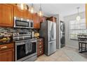 Modern kitchen featuring stainless steel appliances, granite countertops, and tile backsplash at 5100 Burchette Rd # 1606, Tampa, FL 33647