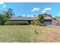 Modest single story home with an attached garage and front yard at 5101 Estates Cir, Sarasota, FL 34243