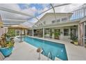 Relax by the covered lanai featuring a large pool, comfortable seating, and a serene backyard view at 6467 Rubia Cir, Apollo Beach, FL 33572