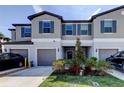 Charming townhome featuring a gray exterior, blue shutters, and well-maintained landscaping at 8294 Corner Pine Way, New Port Richey, FL 34655
