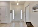Bright and airy foyer with tile flooring, a front door with sidelights, and neutral decor at 8421 Pine River Rd, Tampa, FL 33637