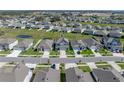 Aerial view of a neighborhood showcasing a well-maintained lawn with similar styled homes at 11232 Bram Bay Ct, San Antonio, FL 33576