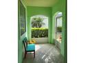 Cozy porch with bench seating and views of lush landscaping and a tranquil exterior at 1318 Misty Greens Dr, Sun City Center, FL 33573