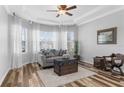 Inviting living room featuring stylish wood floors, a bay window, and recessed lighting at 13424 Hunters Point St, Spring Hill, FL 34609