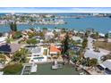 Stunning aerial view of waterfront homes showcasing private docks and beautiful landscaping on the open water at 14184 W Parsley Dr, Madeira Beach, FL 33708