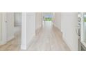 Inviting hallway with wood floors leading to other rooms in the home at 31430 Hayman Loop, Wesley Chapel, FL 33545