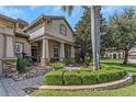 Inviting front yard with lush landscaping and stone accents leading to the entryway at 3668 Janus Way, Palm Harbor, FL 34685