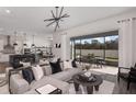Bright living room with modern furnishings, opening to an outdoor dining area, creating a seamless indoor-outdoor flow at 37195 Clinch Cir, Zephyrhills, FL 33540