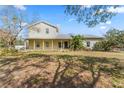 Charming two-story home features a cozy front porch and well-maintained lawn at 403 Indian Meadow Ct, Wimauma, FL 33598