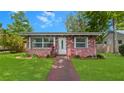 Charming brick home featuring a well-manicured lawn and bright white front door at 4424 19Th N St, St Petersburg, FL 33714