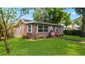 Beautiful brick home with green lawn and a walkway leading to the front door at 4424 19Th N St, St Petersburg, FL 33714